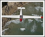 Motor Falke Glider flying over Watego Beach.jpg