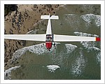 Motor_Falke_Glider_flying_over_Watego_Beach.jpg